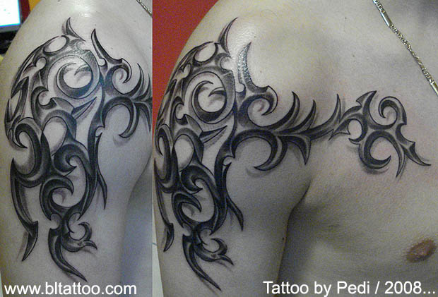 tribal tattoos chest to arm. chest tattoos for men. chest