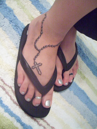 She has gone for a rosary tattoo pretty simple but nice.
